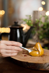 slice of yellow pear cake on wooden background with bokeh lights
