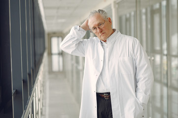 Senior in a hall. Doctor in a uniform. Man in a glasses.