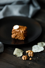 brown cakes cupcake with colored chocolate glaze served on a black plate stylish composition with walnut
