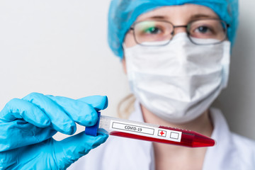 A scientist holds a test tube with a blood test. A blood test for infection with a coronavirus or other infectious disease