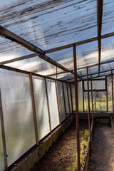 Fototapeta premium The small greenhouse is ready for work on a sunny spring day.