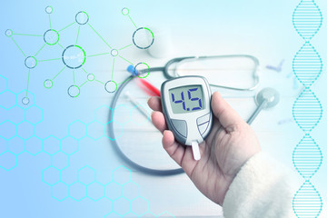 digital blood glucose meter in female hands on a blue technological background, concept of health, medical technology, patient monitoring