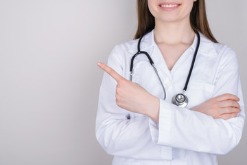 Cropped close-up photo of pretty beautiful confident intern presenting demonstrating empty blank space near her shoulder pointing finger isolated grey background