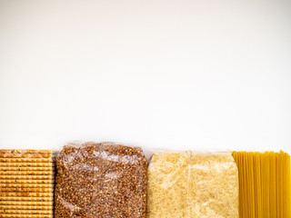 Biscuits, buckwheat, rice, pasta on a white background. Copy space