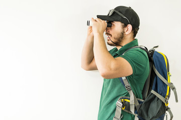 Young man looks through the binoculars.