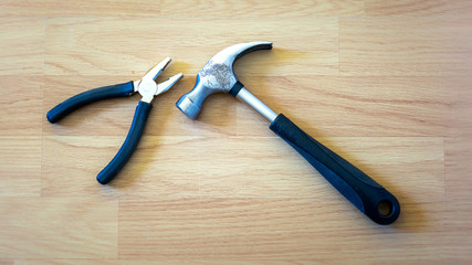 Hammer placed on wooden floor signifying wood work with copy space for your text