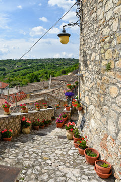 A narrow street between the old houses of Gesualdo, a village in the province of Avellino