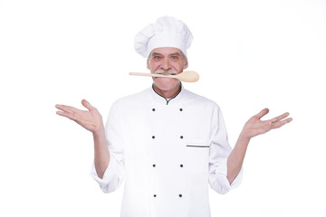 Male chef in uniform holding wooden spoon on mouse while staying on white background