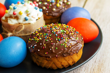 Decorated pumpkin cakes with chocolate, candied fruits and colored Eggs