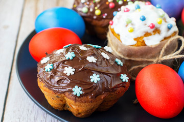 Decorated pumpkin cakes with chocolate, candied fruits and colored Eggs