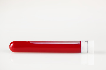 Test tube with blood and white sticker isolated on white. Background with copy space. Coronavirus. Horizontal.