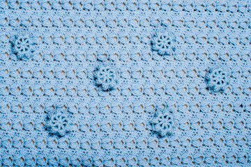 Knitted texture. Fragment of blue hand-made napkin with elegant pattern and decorative elements crocheted close-up. DIY concept. Background for your design, wallpaper