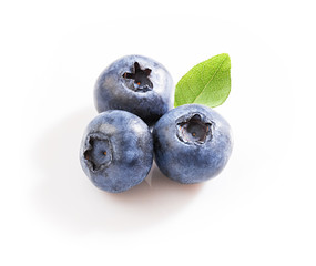 Group of three blueberries with leaf on white background. Isolated
