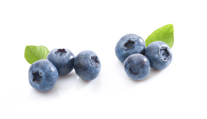 Groups of blueberries with leaves on white background. Isolated