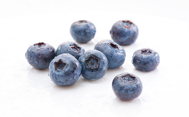 Group wet blueberries on white background. Isolated