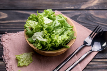 Fresh salad with lettuce and olive oil in a deep piala, on a dining table