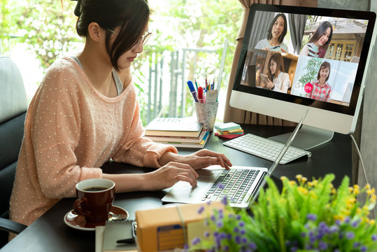 Asian Woman Work From Home During Corona Virus, COVID-19 Out Break Use Laptop For Teleconference With Her Teamates