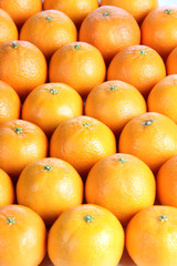 Fresh oranges fruit lie in rows in a store