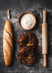 Bakery black background with bread and roll flat lay