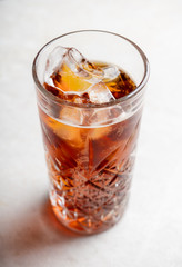 Cold cola beverage in glass with ice. Selective focus. Shallow depth of field.