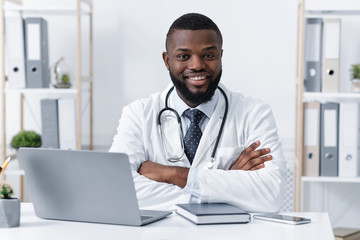 Smiling african american doctor working in clinic