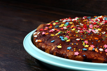 Homemade easter cake on a tray, brown wooden background. Paschal cake. Sweet
