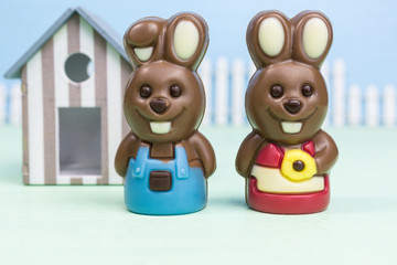 easter chocolate bunny boy and girl with a house in the background