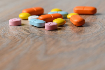 Assorted color tablets close-up on the table. Concept of protection and treatment of coronavirus infection. Copy space.