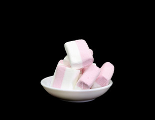 Fototapeta na wymiar Gluten free kids marshmallows in glass on black background