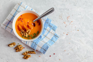 Fototapeta premium Creamy pumpkin soup-puree in a bowl on light background 