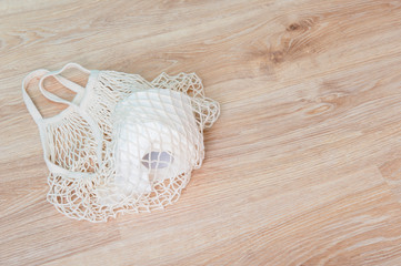 Mesh bag with roll of toilet paper. Concept of problem with, hygiene, virus, health and panic