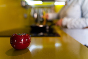 Timer on the yellow surface of a kitchen