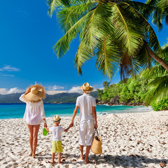 Family with three year old boy on beach. Seychelles, Mahe.