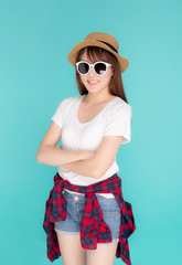 Fototapeta premium Beautiful portrait young asian woman wear hat and sunglasses smiling expression confident enjoy summer in vacation isolated on blue background, girl cheerful wear fashion travel concept.