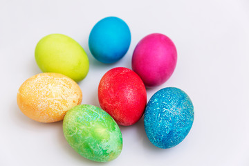 Beautiful multi-colored Easter eggs on a white background. Religious tradition. Space for text.
