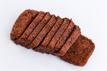 Sliced Russian Borodino brown bread on a white background. Healthy eating and traditions. Close-up.
