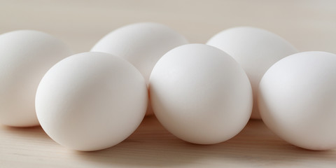 fresh white chicken eggs on lie on a wooden surface