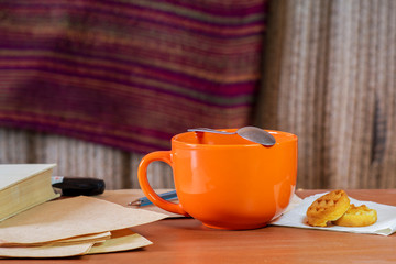 Cozy still life with an orange mug and a book