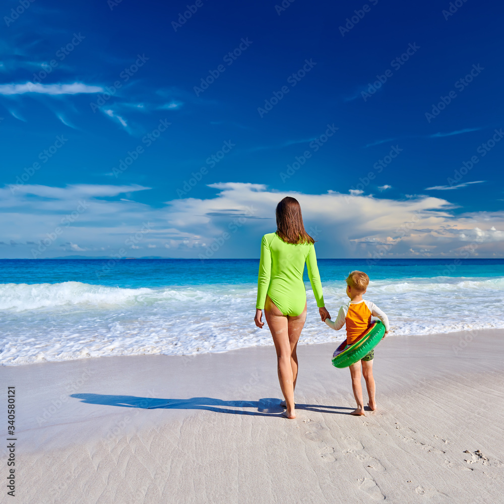 Wall mural toddler boy on beach with mother