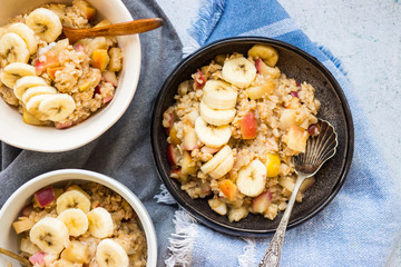 Oatmeal granola porridge with apple and banana fruits and nuts. Vegan healthy sweet breakfast