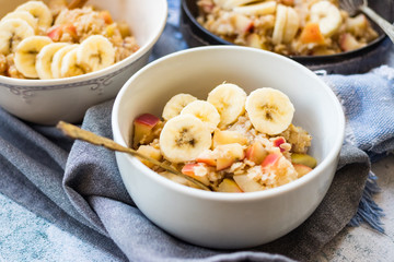 Oatmeal granola porridge with apple and banana fruits and nuts. Vegan healthy sweet breakfast