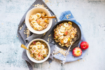Oatmeal granola porridge with apple and banana fruits and nuts. Vegan healthy sweet breakfast