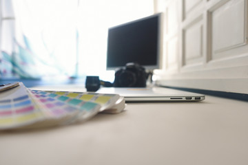 
Photographer table with equipment and color palette.