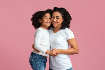 Fototapeta premium Happy Black Family, Mom And Daughter, Hugging And Smiling At Camera
