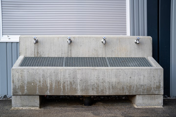 Fountain with a grate and 4 taps to clean shoes