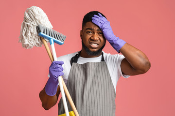 Worry African Man With Mop And Broom, Touching Head In Despair