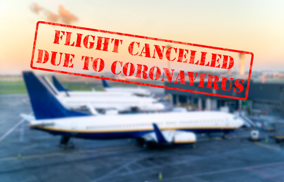Defocused view of grounded passenger airplanes on empty and closed airport due to coronavirus