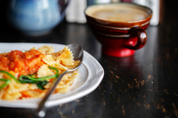 Homemade farfalle, with spinach and tomato sauce