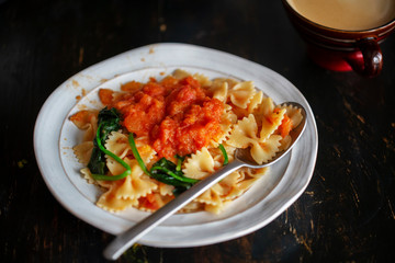 Homemade farfalle, with spinach and tomato sauce