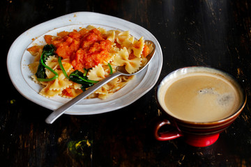 Homemade farfalle, with spinach and tomato sauce